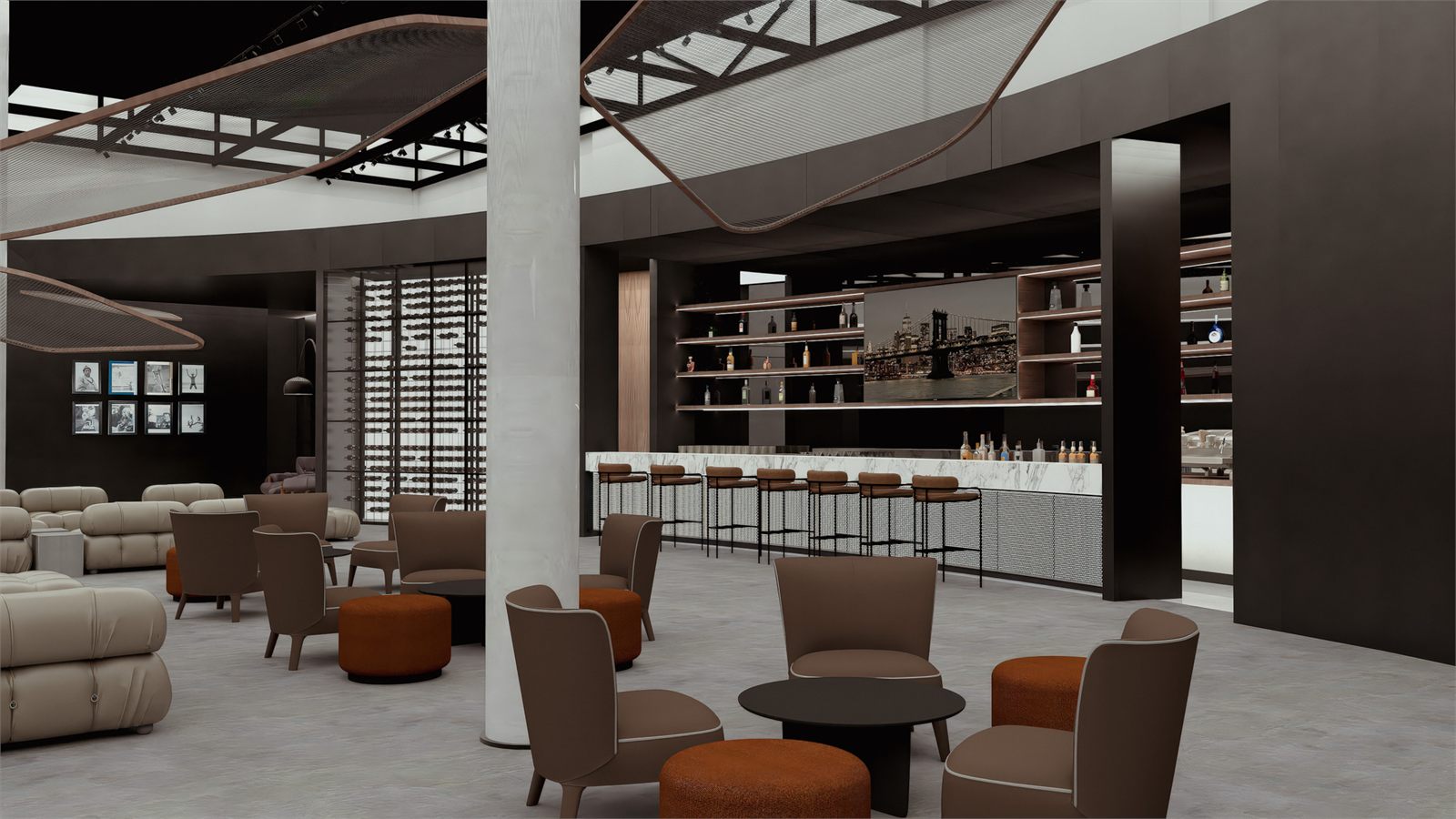 Bar counter and stools seen past armchairs and ottomans