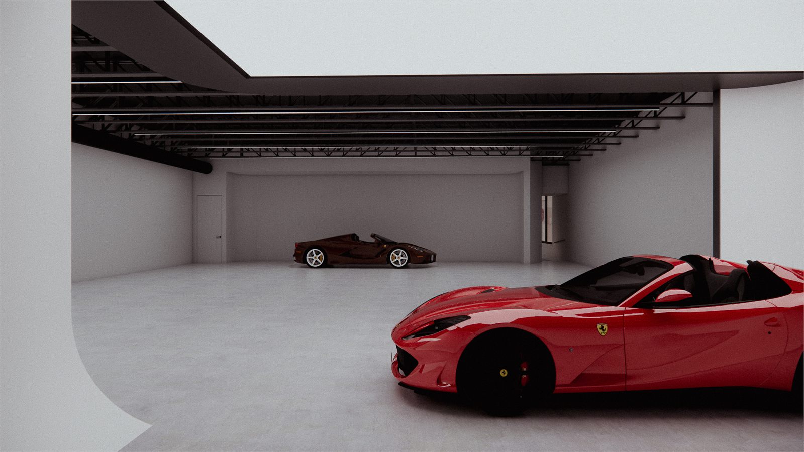 Red sports car on the studio floor with a second car in the cove beyond
