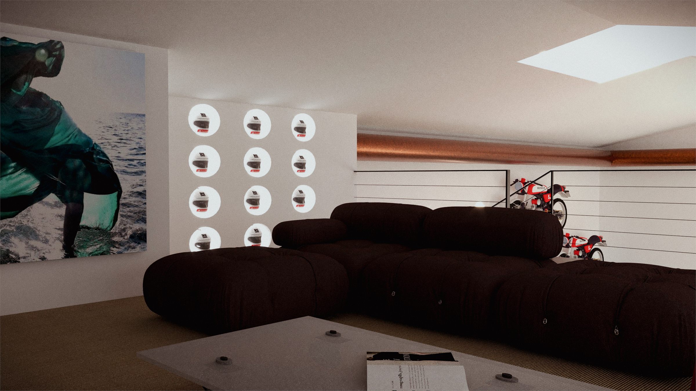 Deep brown modular sofa below a large photographic mural, wheels displayed on the wall opposite